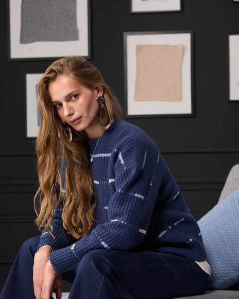Woman wearing ENEX Cadence denim blue striped merino wool sweater