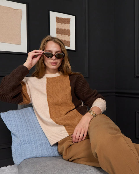 Woman wearing ENEX Ridge caramel cable knit color block sweater