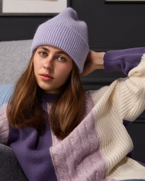 Woman wearing ENEX Ridge lavender cable knit color block sweater